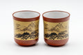 Japanese Teacup Pair - Two Tokoname-yaki yunomi - 125ml - the pair of red Tokoname-yaki cups side by side, front view showing the mountain landscape scene