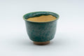 Japanese Teacup - Green Yuteki Glazed Koishiwara-yaki Yunomi - 90ml - front view showing the cream glazed interior