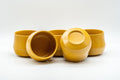 Japanese Tea Set - Yellow Debeso Kyusu with 5 Yunomi - the teacups arranged, some tilted to show the interiors