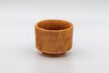 Japanese Teacup - Orange Glazed Hantsutsu-gata Guinomi - 45ml - three-quarter front view of the orange glaze