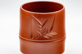 Japanese Teacups - Pair of 亮泉 朱泥 Tsutsu-gata Tokoname-yaki Yunomi - 140ml - closeup of a single cup showing the bamboo engraving and node detail