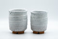 Japanese Teacups - Pair of Shino Glazed Stoneware Tsutsu-gata Meoto Yunomi - front view of the pair of white shino-glazed cups