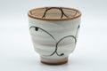 Japanese Teacups - Pair of Brush Glazed Hasami-yaki Yunomi - 170ml - closeup of a single cup showing the blue and orange brushwork