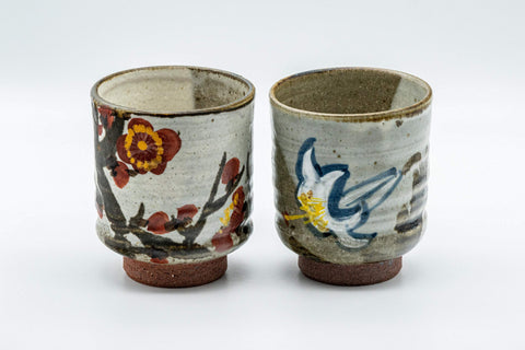 Japanese Teacups - Pair of Floral Tsutsu-gata Yunomi - 200ml - front view of the pair, one cup painted with red flowers and the other with a white lily