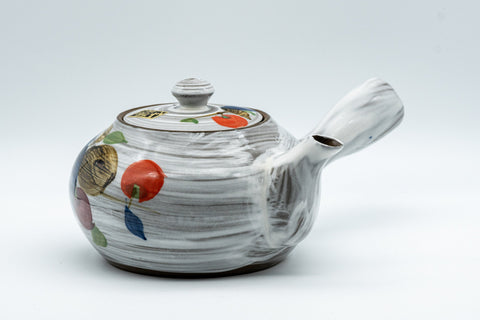 Tezumi — Floral brush-glazed kyusu teapot, three-quarter view showing the lid and painted persimmon and grape motifs