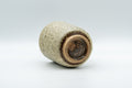 Japanese Teacup - Milky Green Koishiwara-yaki Yunomi - 180ml - the cup resting on its side showing the unglazed foot and base