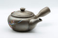 Tezumi — Orchid-decorated kyusu teapot, three-quarter view showing the lid and painted orchid