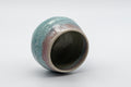 Japanese Teacup - Turquoise Obori Soma-yaki Guinomi - tilted view showing the crazed turquoise and pink glaze