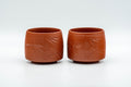 Japanese Teacups - Pair of Bamboo Hantsutsu-gata Tokoname-yaki Yunomi - 130ml - the pair of red Tokoname-yaki clay cups side by side, front view showing the carved bamboo motif