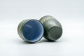 Japanese Teacups - Pair of Green Ryokudei Tokoname-yaki Yunomi - 130ml - the pair tipped on their sides showing the blue-glazed interiors