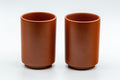 Japanese Teacups - Pair of Nerikomi Tsutsu-gata Tokoname-yaki Yunomi - side view of the pair with plain red clay bodies