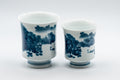 Japanese Teacups - Pair of 畑萬陶苑 Meoto Arita-gata Yunomi - front view of the pair of blue and white porcelain teacups with a painted village scene
