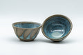 Japanese Teacups - Pair of Stoneware Asagao-gata Guinomi with Cyan Glazed Interior - 50ml - three-quarter view of the pair of small cups showing the cyan-glazed interiors and striped exteriors