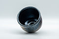 Japanese Teacup - Metallic Bronze Glazed Yunomi - 200ml - the cup tipped to show the blue oil-spot tenmoku glazed interior
