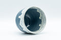 Japanese Teacup - Steel Blue Yunomi with White Drip Glaze - 180ml - the cup tipped on its side showing the glazed interior