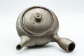 Tezumi — Orchid-decorated kyusu teapot, front three-quarter view showing the lid knob