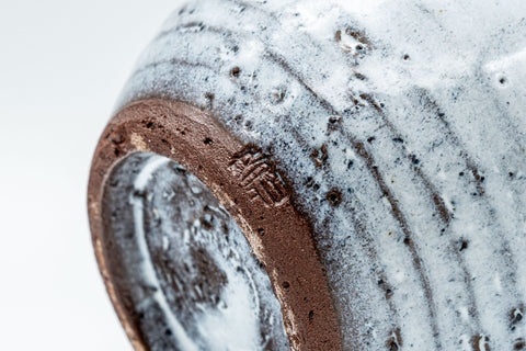 Japanese Teacup - White Glazed Spiral Yunomi - 125ml - angled closeup showing the exposed clay foot and spiral body
