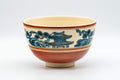 Japanese Matcha Bowl - Zuiun Wan-nari Kyo-yaki Chawan - 450ml - front view of the crazed red-glazed bowl with blue temple and landscape painting