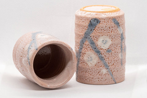 Japanese Teacups - Pair of Meoto Shino Glazed Tsutsu-gata Yunomi - 180ml - one cup tipped to show the interior beside an upright cup