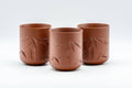 Japanese Teacups - Set of 3 Bamboo Tsutsu-gata Tokoname-yaki Yunomi - 100ml - the three brick-red Tokoname-yaki cups standing in a row