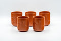 Japanese Teacup - Bamboo Engraved Tokoname-yaki Yunomi - front view of several brick-red Tokoname-yaki cups grouped together