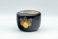 Japanese Natsume - Hira-Natsume Chrysanthemum Lacquer Matcha Tea Caddy - 100ml - front view of the black lacquer caddy with gold chrysanthemum motif