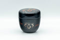 Japanese Natsume - Floral Lacquer Matcha Tea Caddy - 110ml - closed, upright three-quarter front view of the black lacquer caddy