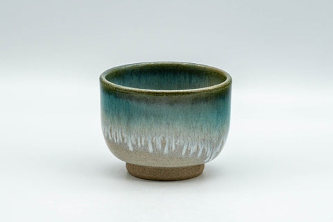 Japanese Teacup - Vibrant Agano-yaki Yunomi - 100ml - front view of the beige teacup with a vibrant turquoise enamel drip