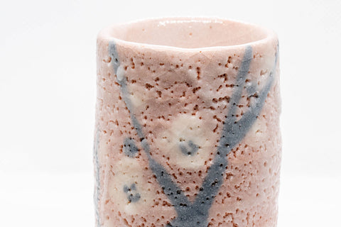 Japanese Teacups - Pair of Meoto Shino Glazed Tsutsu-gata Yunomi - 180ml - closeup of a cup showing the textured pink shino glaze and blue branch