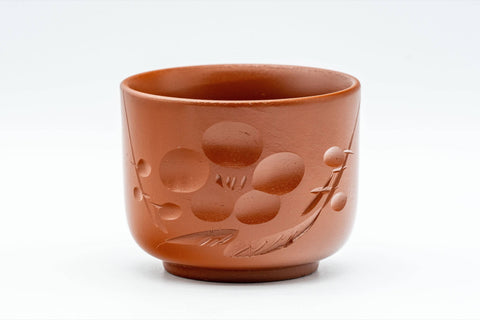 Japanese Teacups - Pair of Plum Blossoms Tsutsu-gata Tokoname-yaki Yunomi - 100ml - front view of one cup showing the engraved plum blossom motif