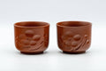 Japanese Teacups - Pair of Plum Blossoms Tsutsu-gata Tokoname-yaki Yunomi - 100ml - front view of the matching pair of red-brown teacups side by side