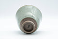 Japanese Teacup - Egret Snowflake Celadon Glazed Yunomi - 140ml - the teacup resting on its side showing the foot and underside