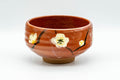 Japanese Matcha Bowl - Red Ume Hantsutsu-gata Chawan - 300ml - front view showing white plum blossoms on the orange-red glaze
