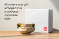 Japanese Matcha Bowl - Metallic Red Tenmoku Glazed Dojimara-gata Chawan - 400ml - promotional image showing the bowl with traditional Japanese gift wrapping