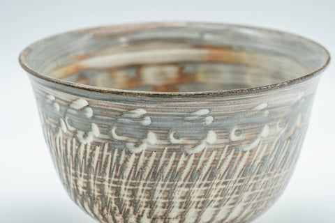 Tezumi — Japanese Teacup - Engraved Floral Spiraling Kyo-yaki Yunomi  - 130ml — tipped to show the interior