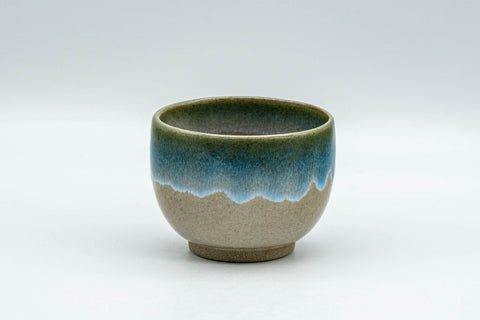 Japanese Teacup - Turquoise Glazed Agano-yaki Yunomi - 90ml - front view of the beige teacup with a turquoise enamel drip near the base