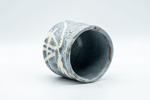 Japanese Teacup - Bamboo Suana Shino Glazed Tsutsu-gata Yunomi with Coaster - tilted view showing the pinhole-textured shino glaze