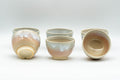 Japanese Tea Set - Tsubaki Kiln Hagi-yaki Kyusu Teapot with 6 Yunomi Teacups - the yunomi teacups grouped together, one inverted to show the foot