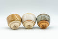 Tezumi — Japanese Teacups - Set of 3 Orange, White, and Grey-Green Guinomi - 35ml — three-quarter view