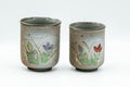 Japanese Teacups - Pair of Floral Green Meoto Yunomi - Arita-yaki - front view of the pair showing the painted flowers