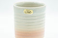 Japanese Teacup - Spiral Tsutsu-gata Hagi-yaki Yunomi - 150ml - closeup of the rim showing the maker's gold stamp