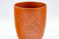 Tezumi — Japanese Teacup - Floral Plum-blossom Engraved Tokoname-yaki Yunomi - 120ml — tipped to show the interior