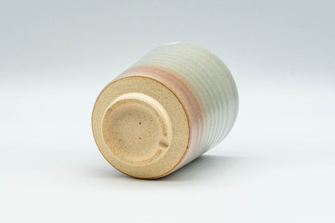 Japanese Teacup - Spiral Tsutsu-gata Hagi-yaki Yunomi - 150ml - tipped on its side showing the unglazed clay foot and base