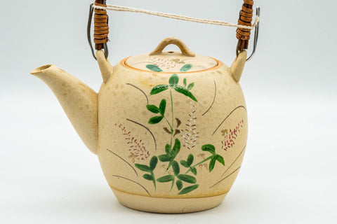 Japanese Tea Set - Floral Beige Glazed Debeso Dobin Teapot and 2 Yunomi Teacups - side view of the beige top-handle dobin teapot with floral decoration