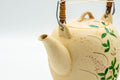 Japanese Tea Set - Floral Beige Glazed Debeso Dobin Teapot and 2 Yunomi Teacups - three-quarter view from the spout side of the dobin