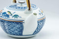 Tezumi — Japanese Dobin - Blue Floral Parrots White Debeso Teapot - 600ml — side profile showing the spout and handle