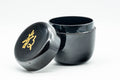 Japanese Natsume - ね Hentaigana Black Lacquer Matcha Tea Caddy - 100ml - opened caddy with lid beside the body, showing the gold ね character