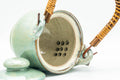 Japanese Tea Set - Green Glazed Dobin Do-ake Teapot with Katakuchi Water Cooler and 2 Yunomi Teacups - top-down view showing the ceramic do-ake filter