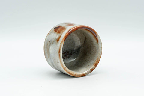 Tezumi — Japanese Teacup - Orange Milky White Shino Glazed Guinomi - 50ml — three-quarter view
