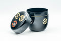 Tezumi — Japanese Natsume - Gold and Red Emblemed Black Lacquer Matcha Tea Caddy - 100ml — front view with the lid on